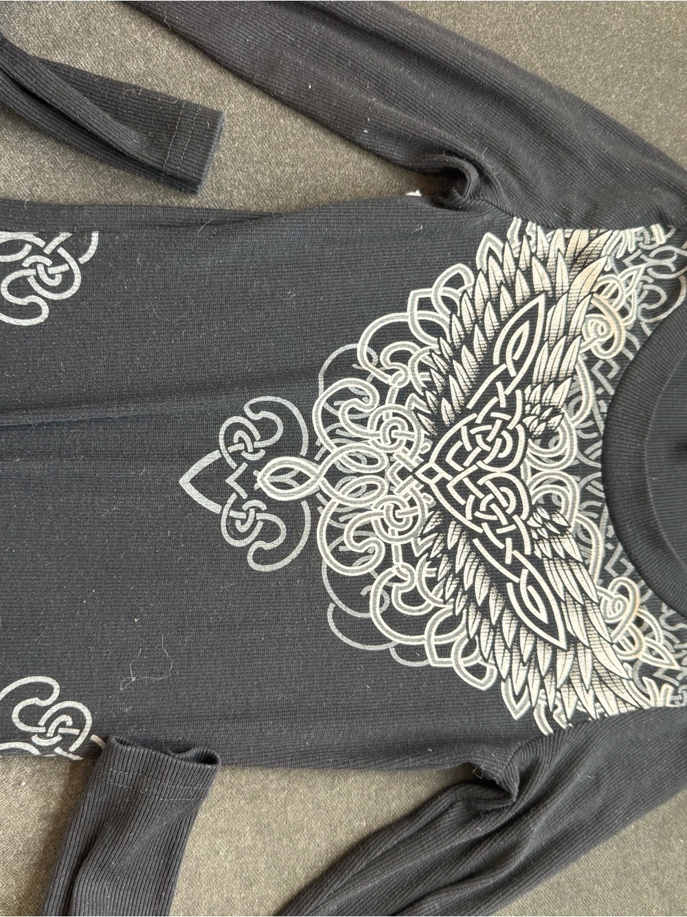 Women’s Black Long-Sleeve Graphic Top with Silver Celtic Wing Motif